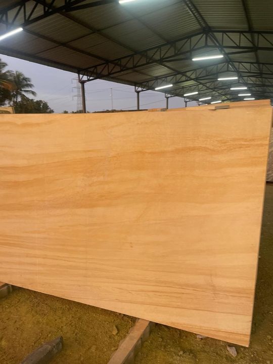 Light golden sandstone granite slab with soft horizontal banding under a shed