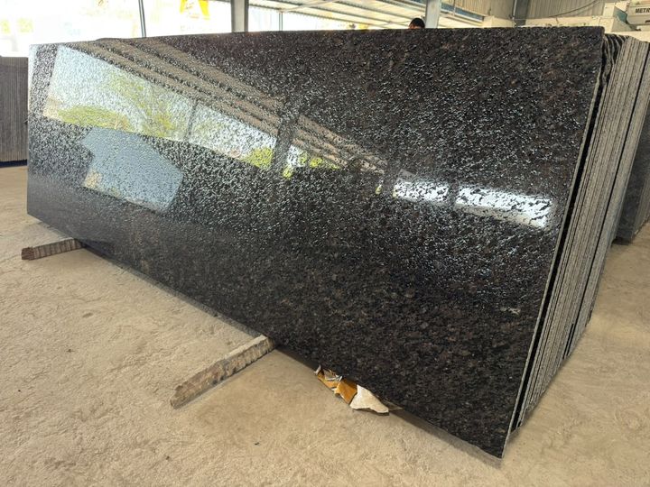 Black and brown granite slab with a textured leathered finish