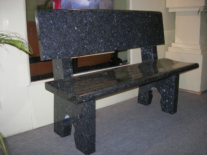 Black granite bench with backrest indoors